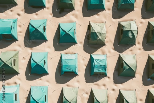 Aerial view of tents in the desert, creating a pattern of shelter and survival in extreme conditions