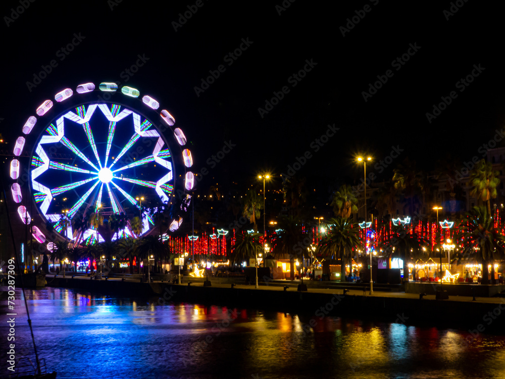 Image of the magic of the holiday season at the Christmas fair with a dazzling Ferris wheel shining bright against the night sky.