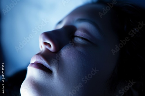 Close-up of a person in blue light, evoking a sense of tranquility and deep relaxation