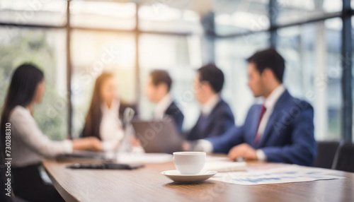 Blurry office meeting scene symbolizing business dynamics, with copy space