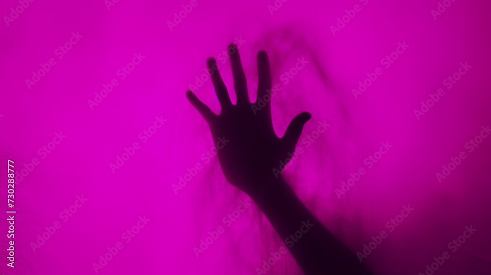 Hand silhouette on pink background. Blurred human hand shape out of focus