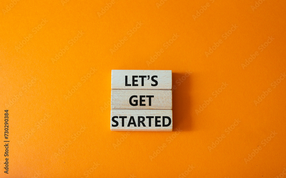 Lets get started symbol. Concept words Lets get started on wooden blocks. Beautiful orange background. Business and Lets get started concept. Copy space. - obrazy, fototapety, plakaty 