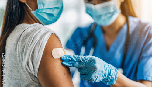 shoulder with bandaid after COVID vaccine  symbolizing vaccination and healthcare