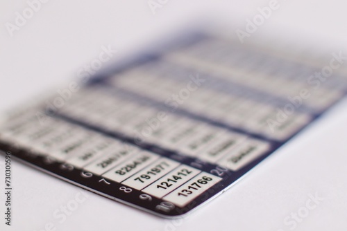 Blurred card bank with one-time password numbers, numbered list