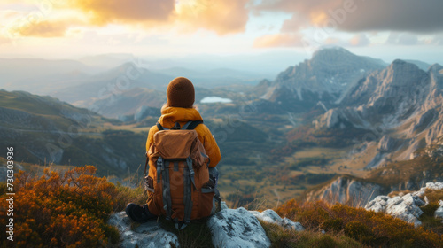 A solo traveler gazing at a majestic mountain range from a peaceful hilltop