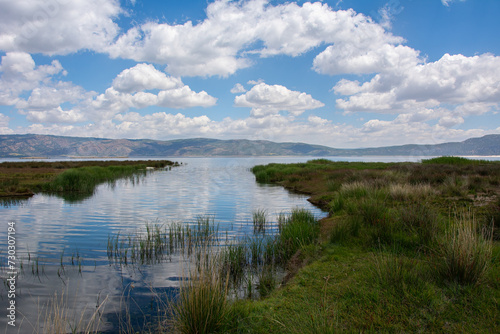 Salda Lake and the stream flowing into the lake with a view of the cloudy sky.