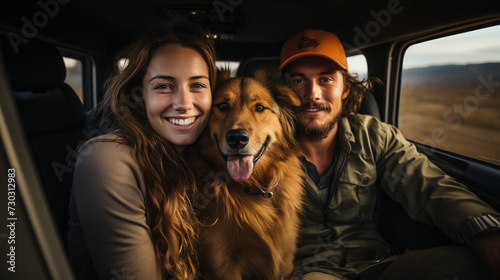 Happy couple with their puppy on a vacation roadtrip