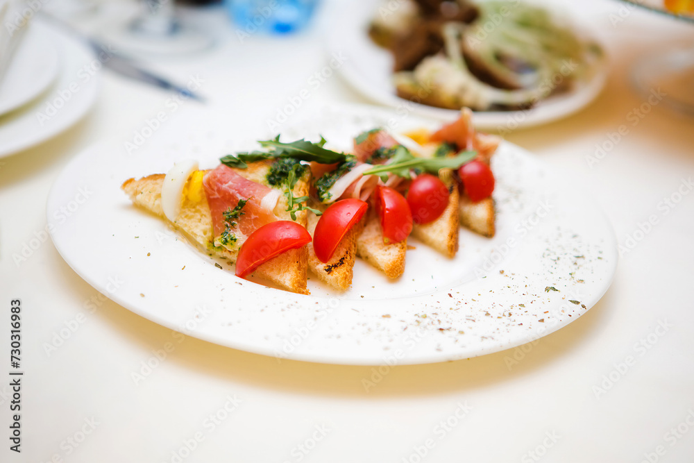 Plate of delicious toast with tomatoes and herbs Plate of delicious toast with tomatoes and herbs
