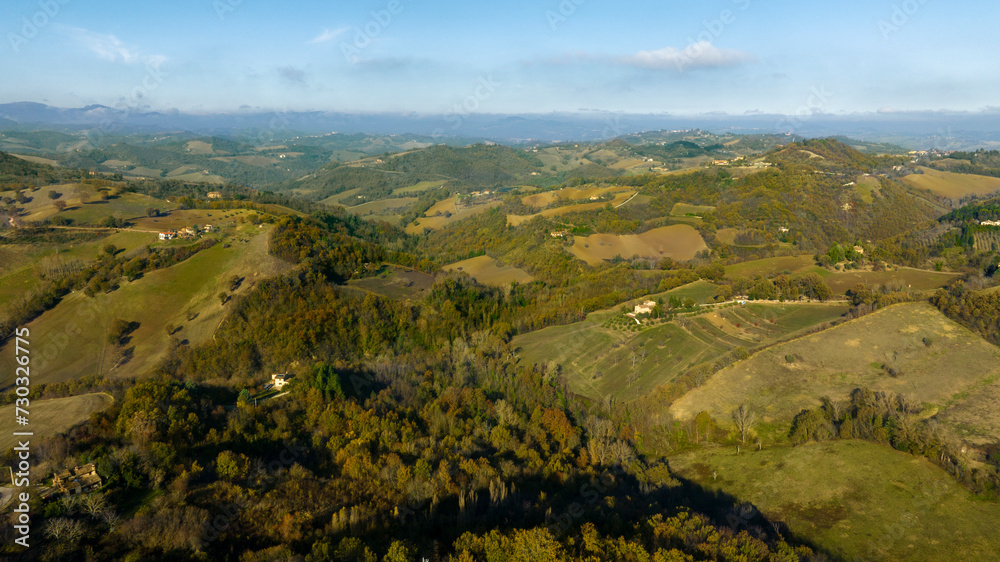 Aerial view on the Irpinia countryside in the province of Avellino, Italy. Among the cultivated fields and woods in the mountains there is some isolated house.
