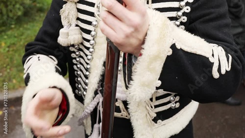Close-up of man torso in dolman, clothes of hussar of XIX century, slow motion