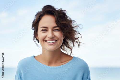 Joyful woman with spontaneous smile enjoying breezy day. Positive emotion and beauty.