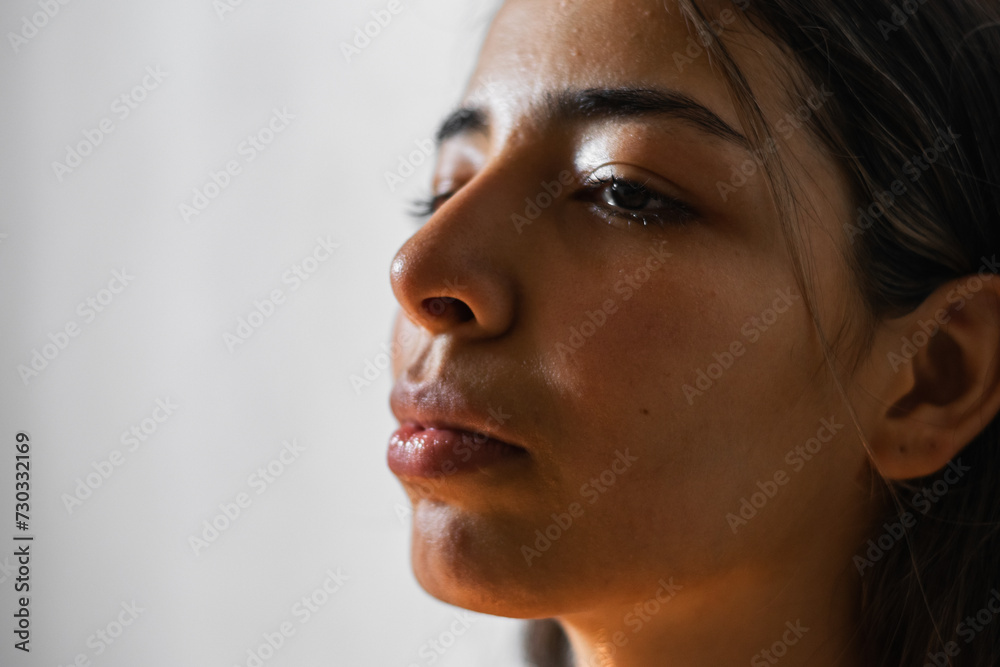 close-up of the face of a brunette Latina woman, with a very sad look and crying. close-up of the face of a brunette Latina woman, with a very sad look and crying.