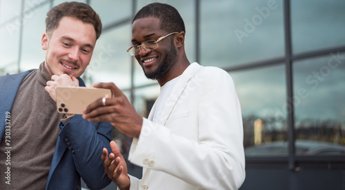 African and caucasian entrepreneur discuss affair on mobile phone.Internet social media addiction concept..