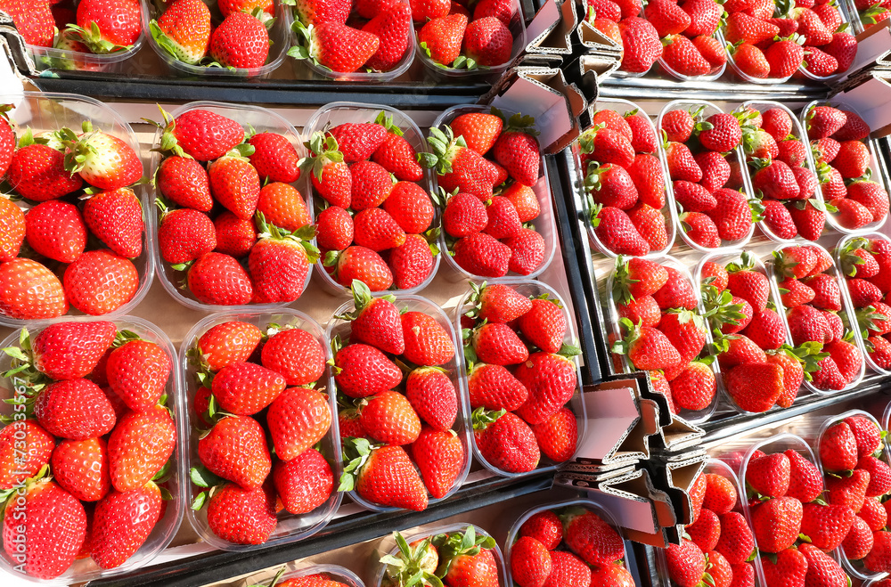 Delectable fragrance of fresh red  strawberries fills the air at the market