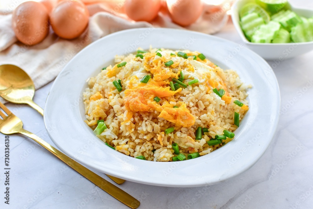 Fried rice with egg on white plate , Thai call kaw pad kai, thai food , asian food, home cooked 