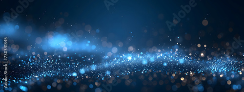 A dark blue abstract background featuring a glow particle effect. The image includes abstract blue lights and star particles, forming a captivating scene with dots on a dark background. photo