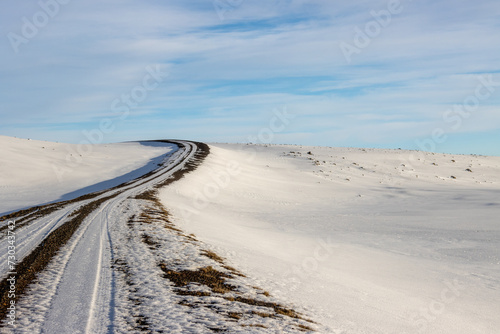 Gravel side road and a white snowy country  Iceland