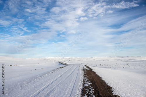 Gravel side road and a white snowy country  Iceland