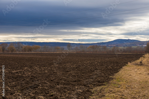 A beautiful lowland landscape overlooking the Palava region. Dark clouds in the sky. Fields and meadows.