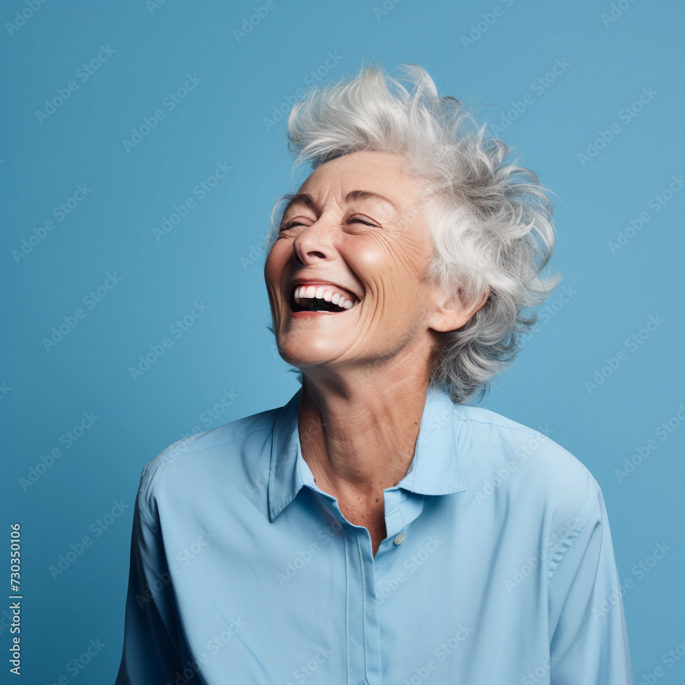 Portrait of a Cheerful Senior woman isolated with blue background Portrait of a Cheerful Senior woman isolated with blue background