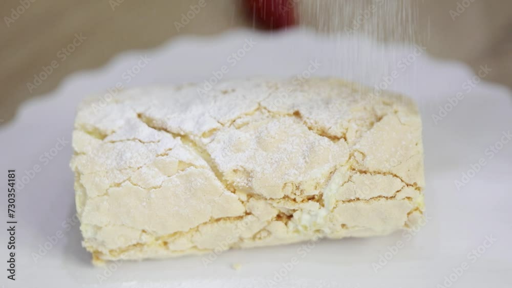 Powdering of turning sweet roulette during cooking, close-up Powdering of turning sweet roulette during cooking, close-up