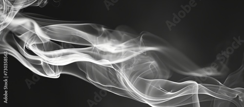 Black and white closeup of incense stick smoke in an abstract image. photo