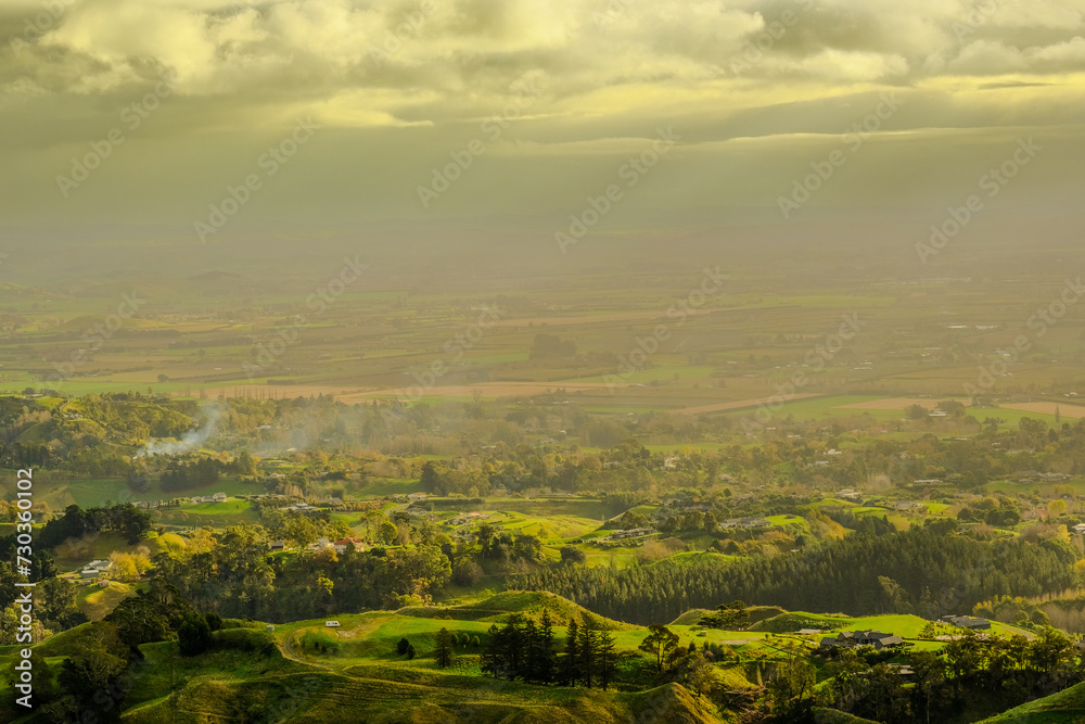 Aerial View of Rolling Hills and Farmland Under Cloudy Sky - Morning Sunrise in New Zealand 