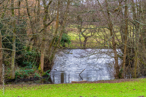 A view towards a lake close to the ruins of Wroxall Priory in Warwickshire on a winter's day photo