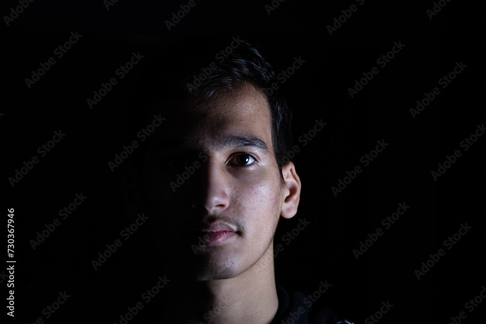 Portrait for teenager in dark and light studio