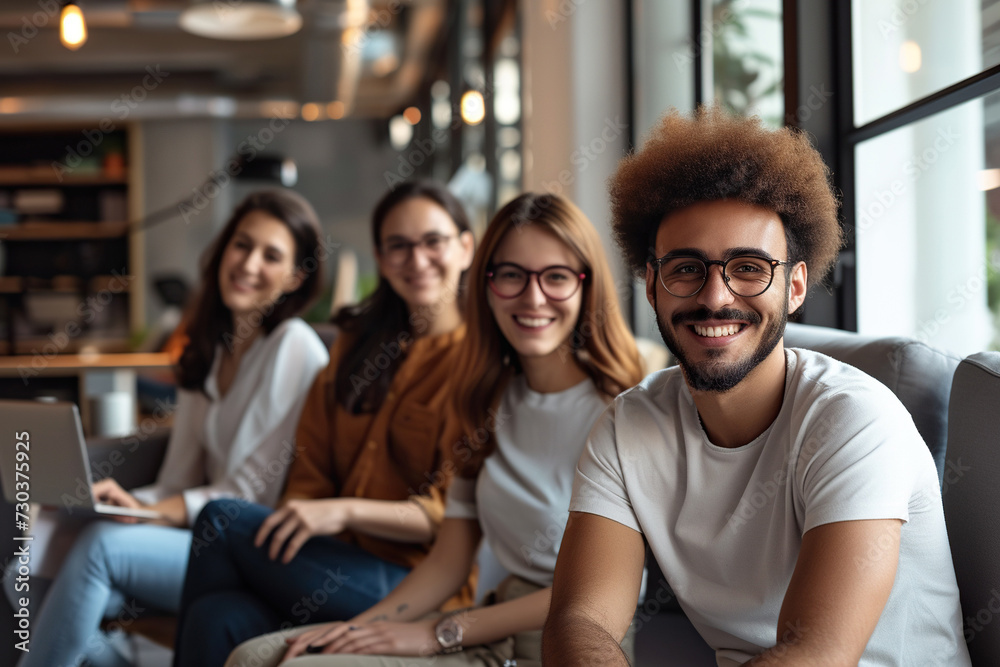 Successful business team smiling and sitting together in a startup office Successful business team smiling and sitting together in a startup office