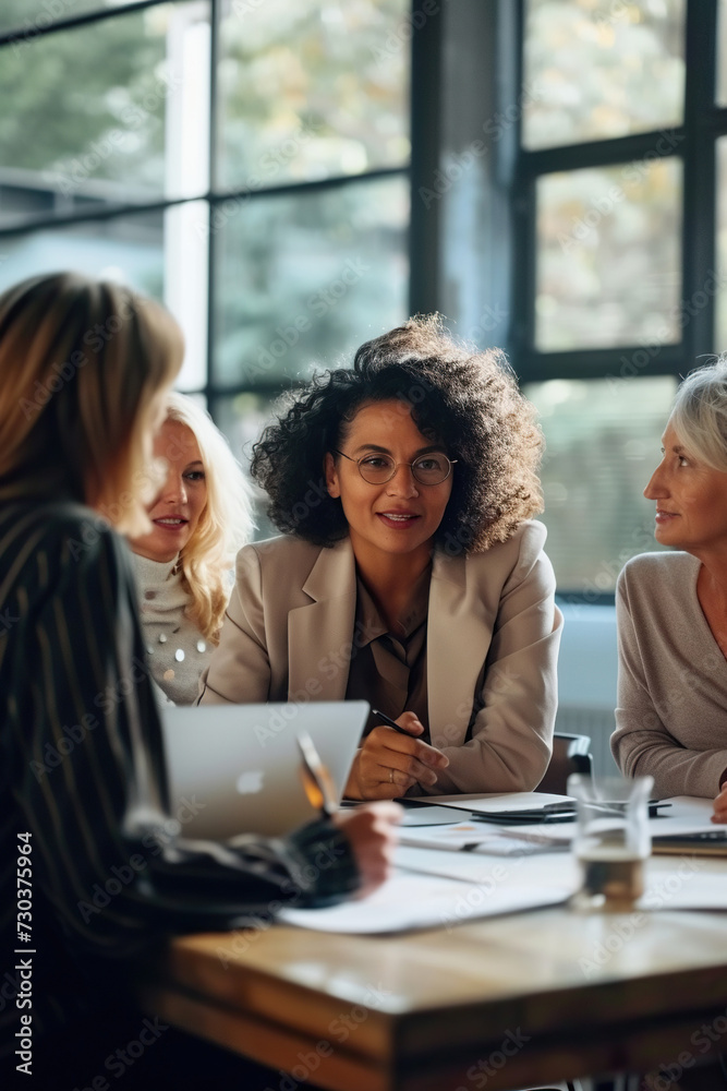 Successful group of business women engaged in productive discussion Successful group of business women engaged in productive discussion