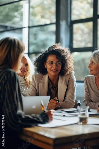 Successful group of business women engaged in productive discussion