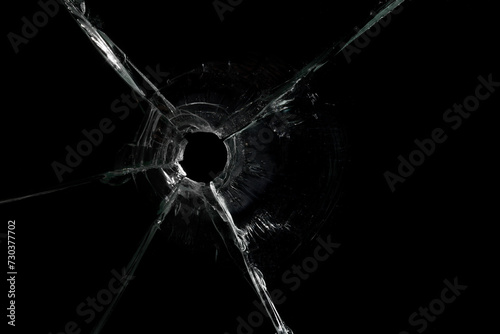 Cracked Pieces Broken Glass Hole on Black Background © Ruslan