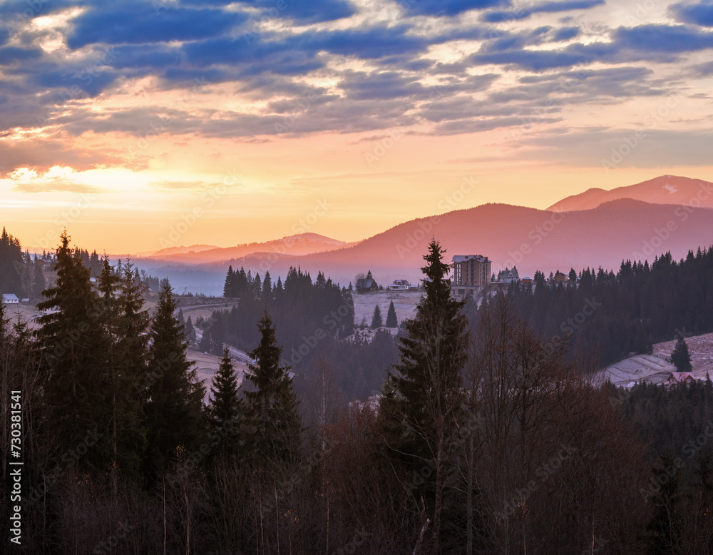 Picturesque sunrise above late autumn mountain countryside.  Ukraine, Carpathian Mountains. Peaceful traveling, seasonal, nature and countryside beauty concept scene.