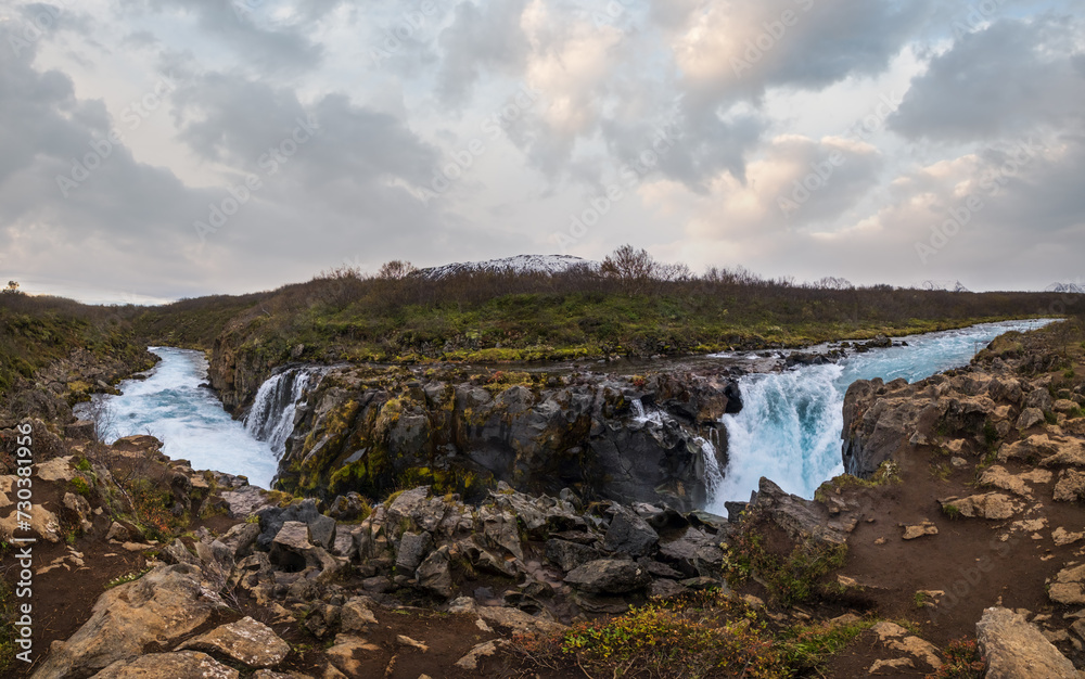 Picturesque waterfall Hlauptungufoss autumn view. Season changing in southern Highlands of Iceland.