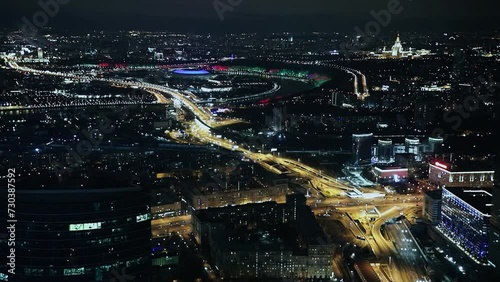  Cityscape with Luzhniki sports stadium and edifice of Moscow State University, transport traffic at night