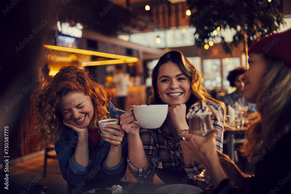 Diverse group of young people sitting in a cafe Diverse group of young people sitting in a cafe