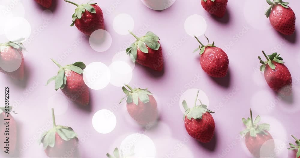 Composition of spots of light over strawberries on pink background Composition of spots of light over strawberries on pink background