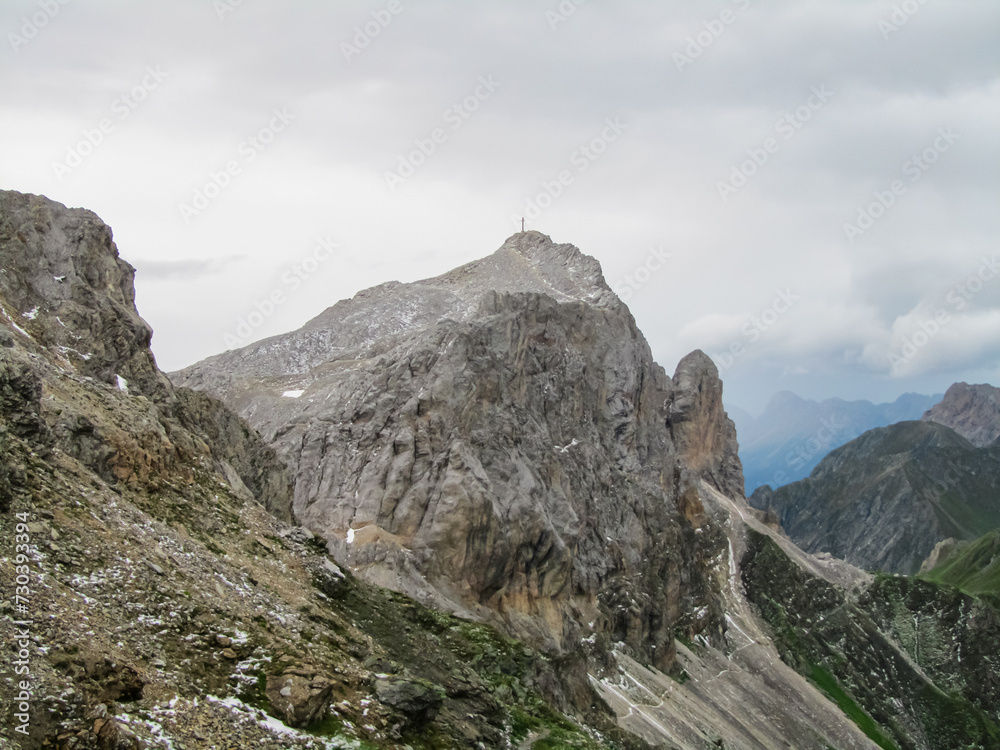 Panoramic view of alpine terrain surrounded by majestic Carnic Alps, Carinthia, border Italy Austria. Scenic hiking trail in wilderness of Austrian Alps. Peace of mind, calmness. Wanderlust in nature