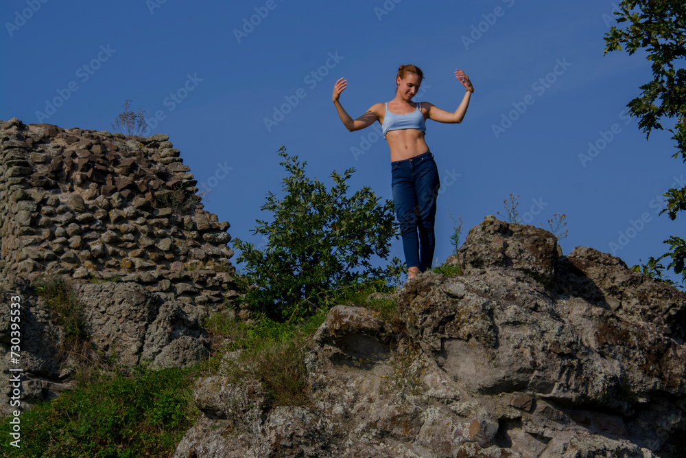 Ruins of the Medieval Fortress of Dregely with a young woman