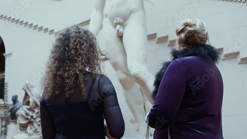  Two women (MR) talk near sculpture of David by Michelangelo at Italian Courtyard in Museum of Fine Arts named by A.S.Pushkin. Slow motion photo