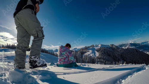Couple relaxing in powder snow in ski resort Dreilaendereck in Karawanks, Carinthia, Austria. Alpine landscape in winter Austrian Alps. Panoramic view of snow capped mountains. Skiing tourism photo