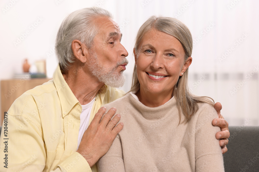 Senior man kissing his beloved woman at home Senior man kissing his beloved woman at home