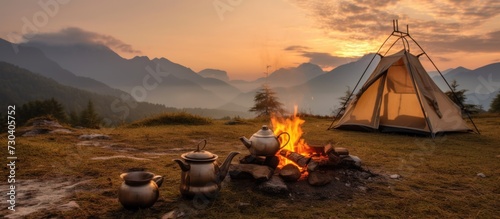 Boil water using a campfire while camping photo