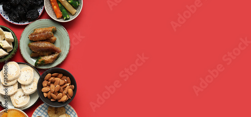 Different Eastern sweets on red background with space for text, top view. Ramadan celebration photo