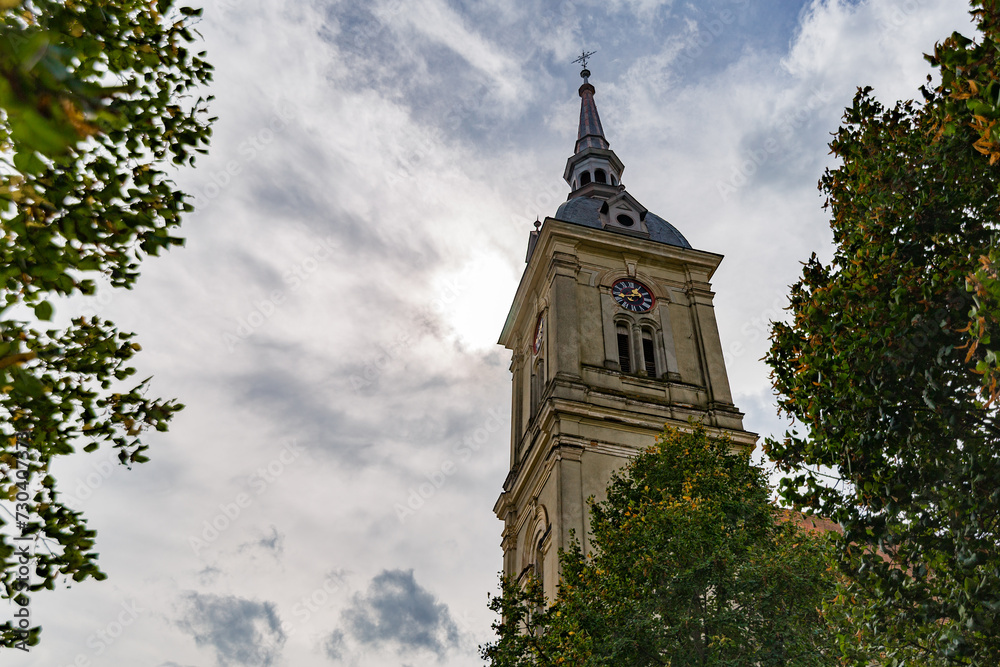 A church bell tower with blue coudy sky