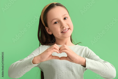 Cute little girl making hea...