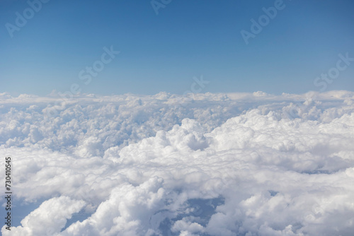 View from the airplane window, clouds, land, and sky © Javi