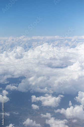 Fototapeta Naklejka Na Ścianę i Meble -  View from the airplane window, clouds, land, and sky