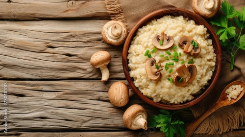 Risotto with brown champignon mushrooms on wooden background